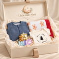 Baby's First Christmas Box open with Gingerbread Man quilt, navy sleep sack, My First Christmas bodysuit and glass ornament